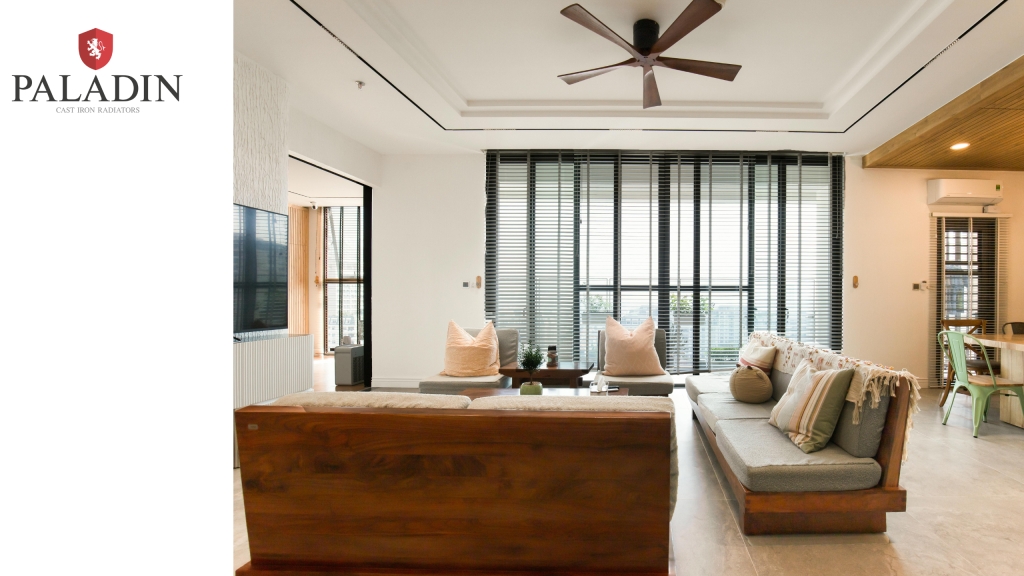 Modern living room with wooden furniture, neutral decor, large windows with blinds, ceiling fan, and ample natural light. Paladin Cast Iron Estate Agents logo is displayed in the top left corner.