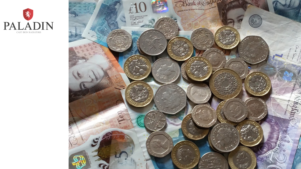 A collection of British pound coins scattered over various UK banknotes, with the Paladin Cast Iron Radiators logo in the top left-hand corner.